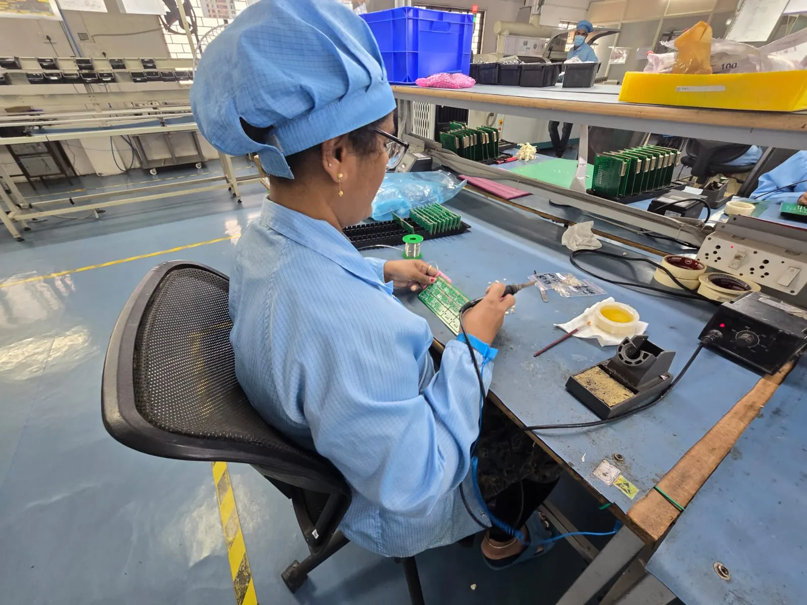 Operator in ESD smock and wrist strap Vishesh electronics manufacturing