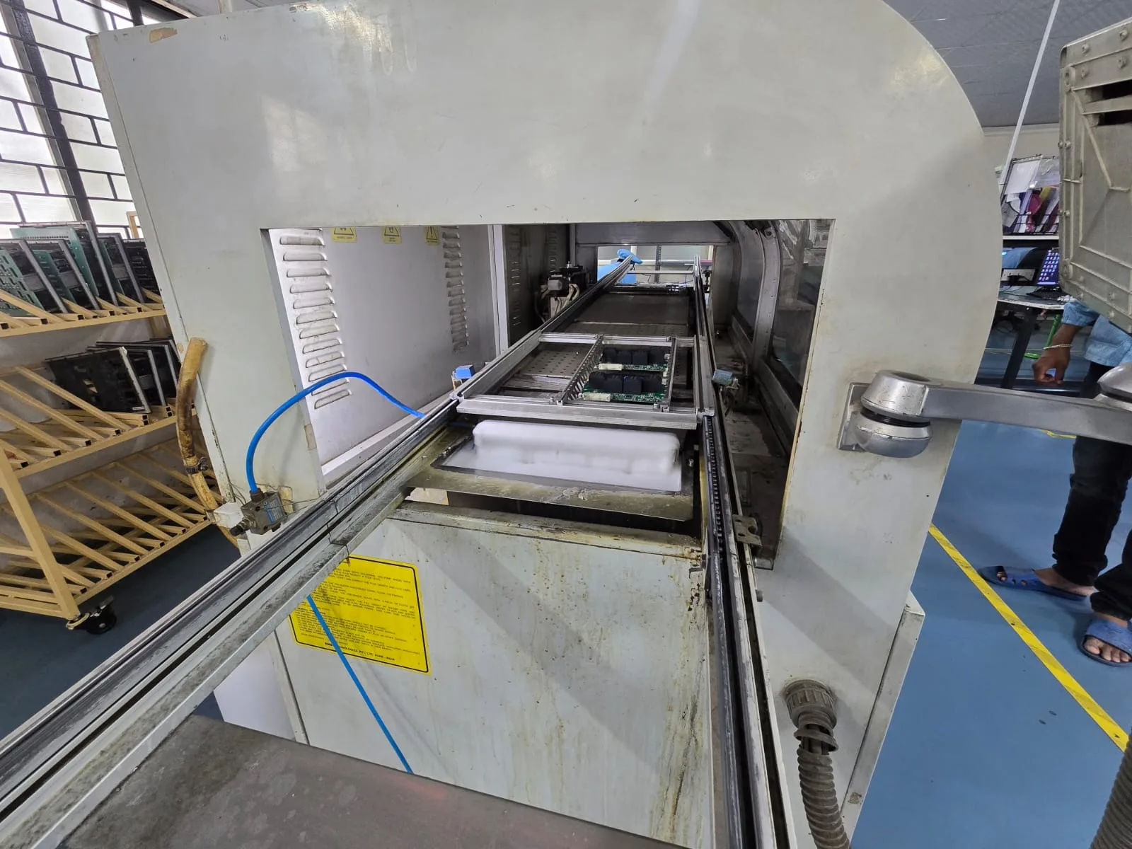 PCB board going through wave soldering machine Vishesh EMS Bangalore